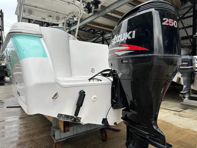 Slide: The Image of 2007 Pro-Line 23 Express boat with Suzuki 250 outboard motor in a storage facility. - 6