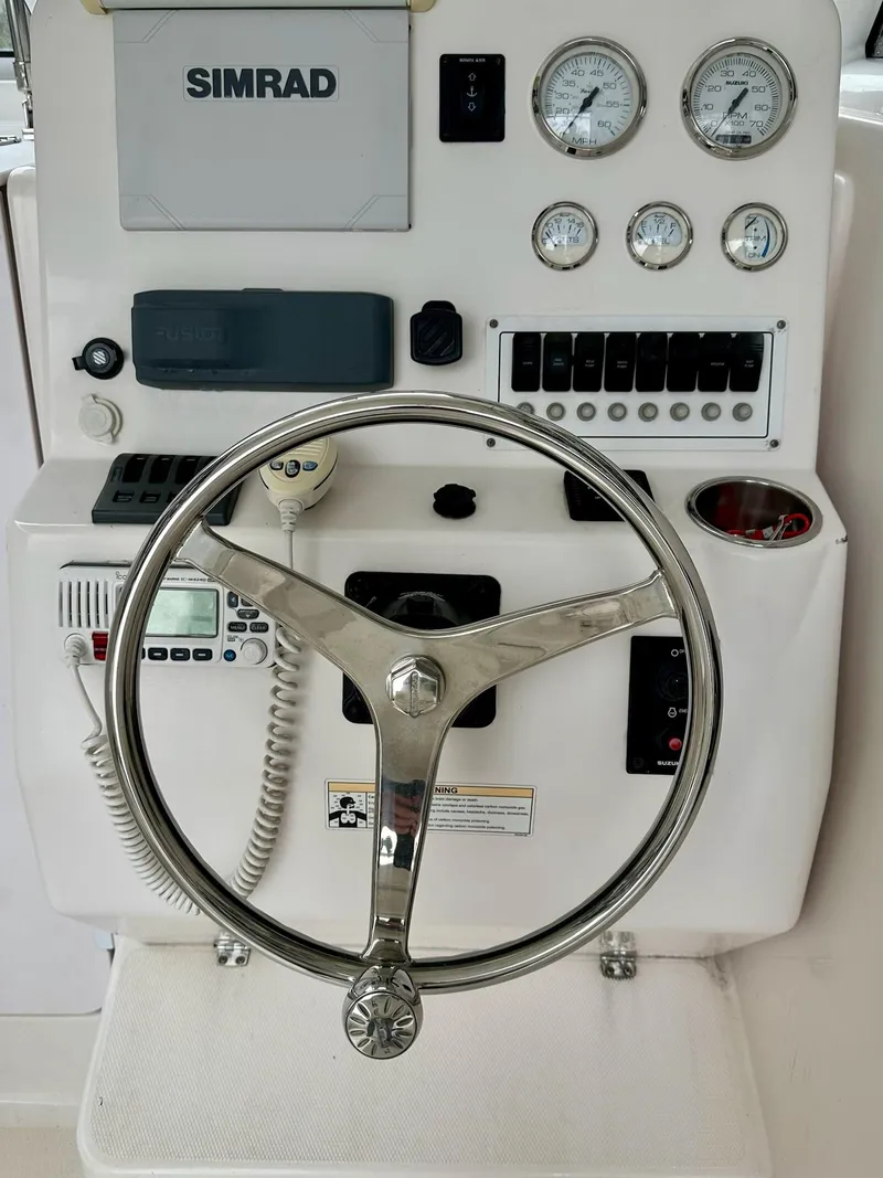 Slide: The Image of 2007 Pro-Line 23 Express boat dashboard with steering wheel and Simrad navigation system. - 7