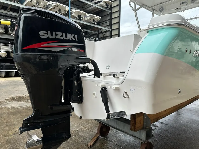 Slide: The Image of 2007 Pro-Line 23 Express boat with Suzuki four-stroke outboard motor in a storage facility. - 8