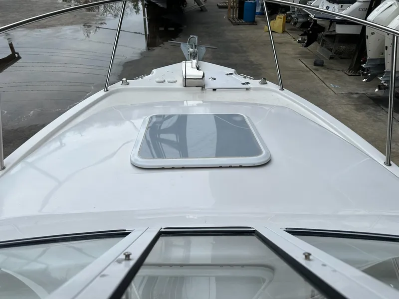 Slide: The Image of 2007 Pro-Line 23 Express boat deck with hatch, docked in a marina. - 9