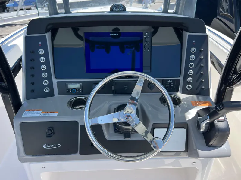 Slide: The Image of 2025 Robalo R232 Explorer dashboard with steering wheel and navigation controls. - 10