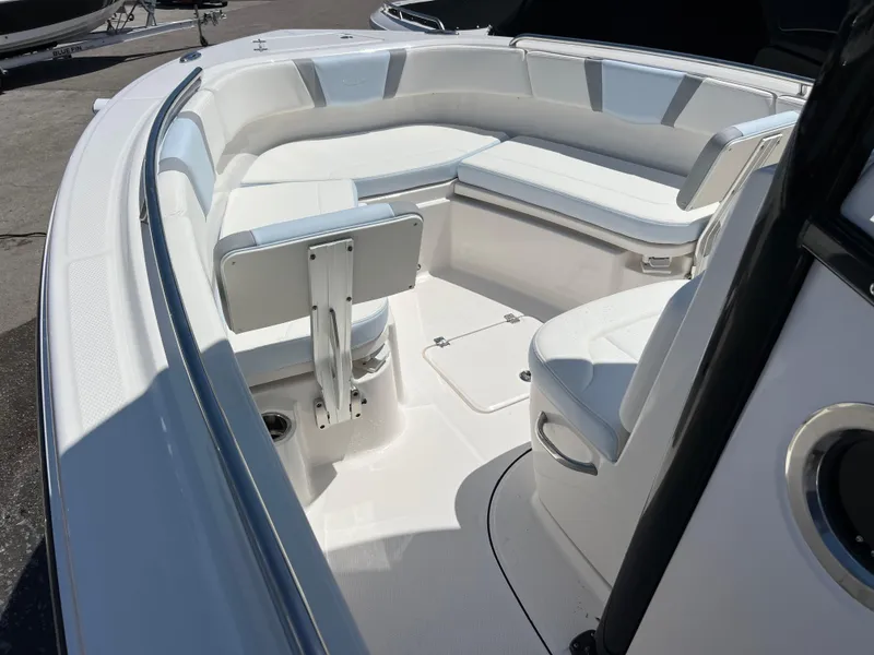 Slide: The Image of 2025 Robalo R232 Explorer boat interior with white seating and modern design. - 11
