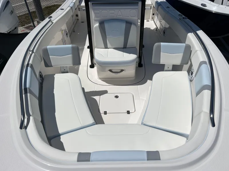 Slide: The Image of 2025 Robalo R232 Explorer boat interior with white seating and storage compartments. - 12