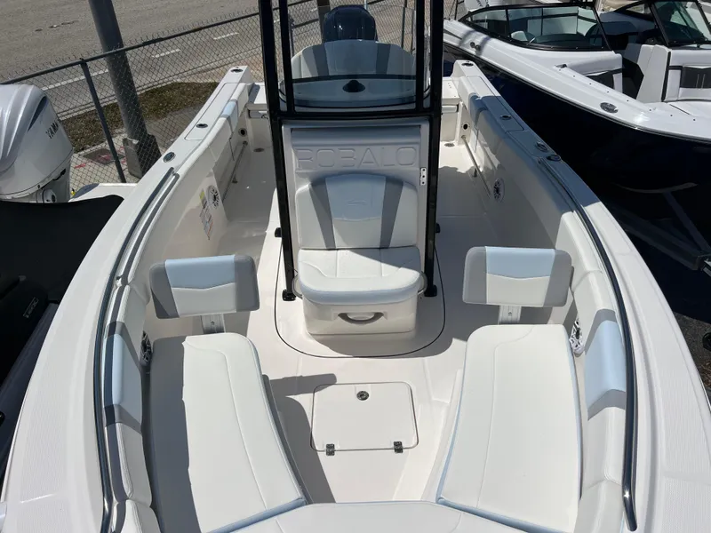 Slide: The Image of 2025 Robalo R232 Explorer boat interior with white seating and storage compartments. - 13