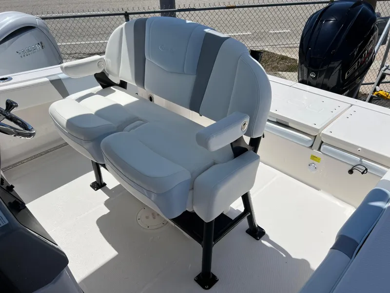 Slide: The Image of 2025 Robalo R232 Explorer boat interior with cushioned seating and steering wheel. - 15