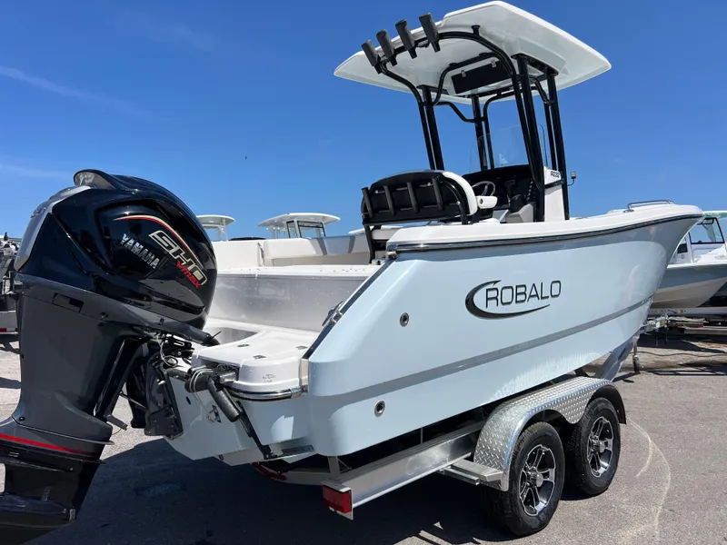 Slide: The Image of 2025 Robalo R232 Explorer boat on trailer with Yamaha outboard motor. - 4