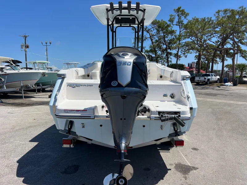 Slide: The Image of 2025 Robalo R232 Explorer boat with powerful outboard motor, parked outdoors. - 5