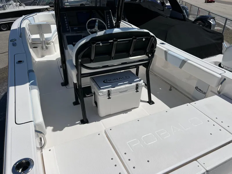 Slide: The Image of 2025 Robalo R232 Explorer boat interior with seating and console, showcasing modern design. - 6