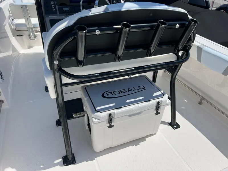 Slide: The Image of 2025 Robalo R232 Explorer boat with rod holders and branded cooler on deck. - 7