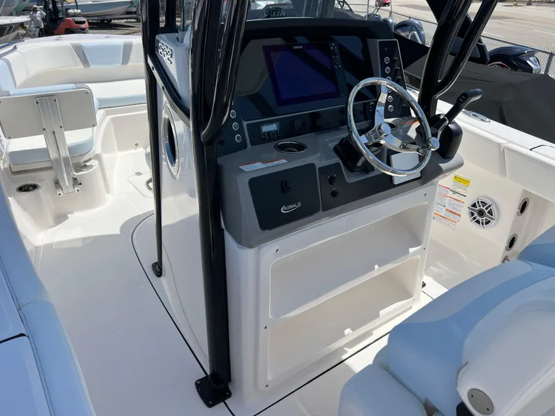 Slide: The Image of 2025 Robalo R232 Explorer boat cockpit with steering wheel and control panel. - 9
