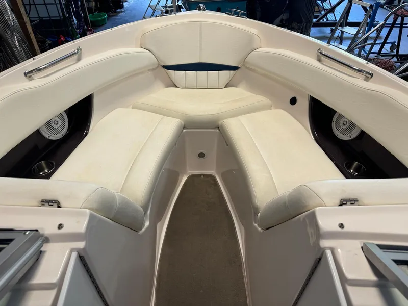 Slide: The Image of 2006 Regal 2200 Bowrider interior with white seating and cup holders. - 11