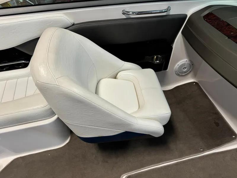 Slide: The Image of 2006 Regal 2200 Bowrider interior with white cushioned seat and carpeted floor. - 16