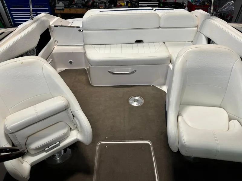 Slide: The Image of 2006 Regal 2200 Bowrider interior with white seating and gray carpet. - 17
