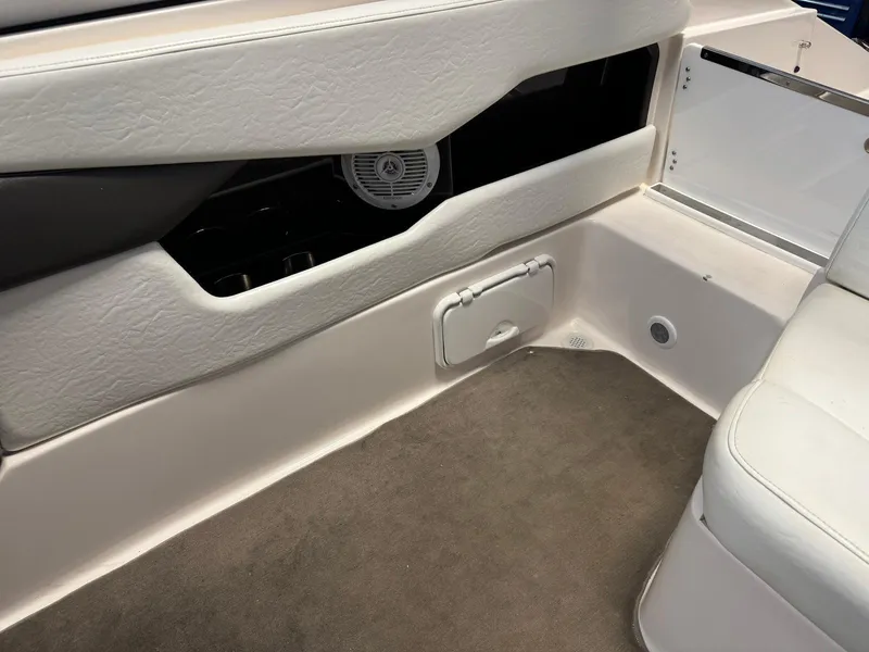 Slide: The Image of Interior of a 2006 Regal 2200 Bowrider boat, featuring white seating and storage compartments. - 18