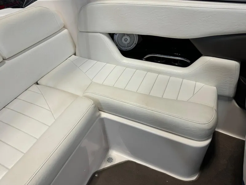 Slide: The Image of 2006 Regal 2200 Bowrider interior seating with white upholstery and speaker detail. - 19