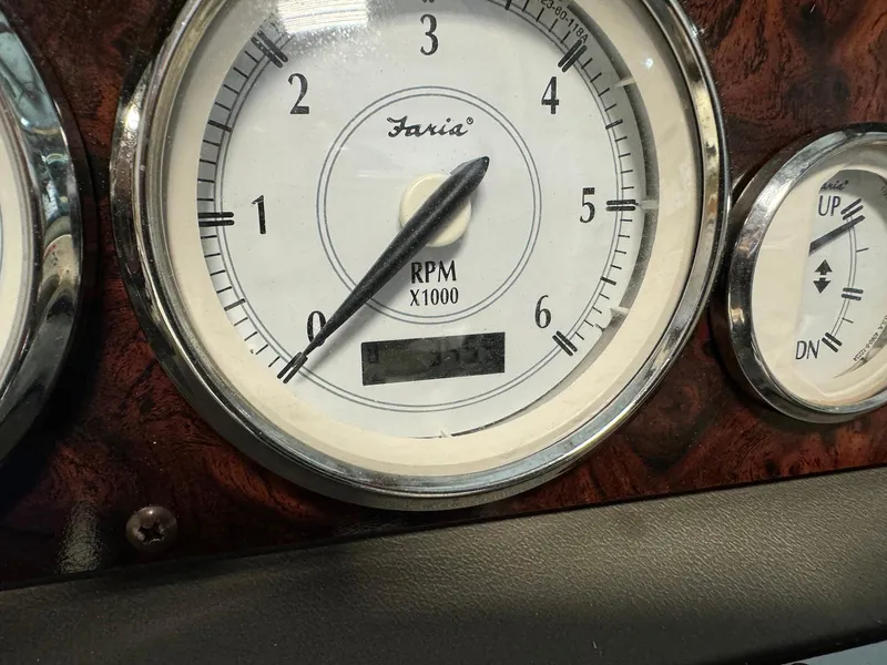 Slide: The Image of Close-up of 2006 Regal 2200 Bowrider RPM gauge, showing Faria brand, wood panel background. - 21
