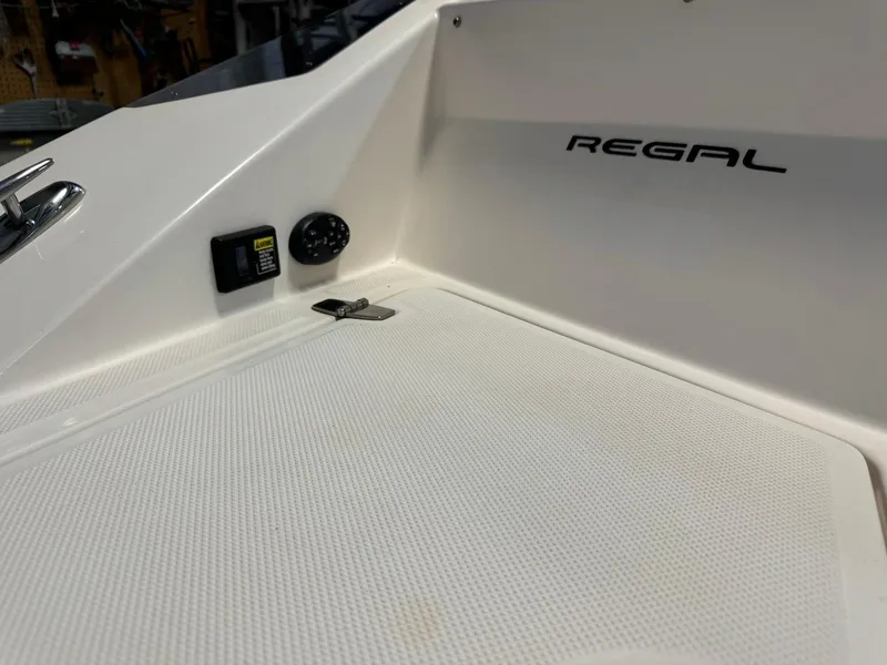 Slide: The Image of 2006 Regal 2200 Bowrider interior detail with logo and control panel. - 23