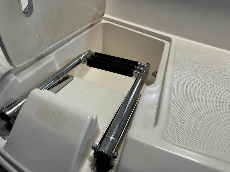 Slide: The Image of 2006 Regal 2200 Bowrider boat ladder compartment with stainless steel folding ladder. - 24