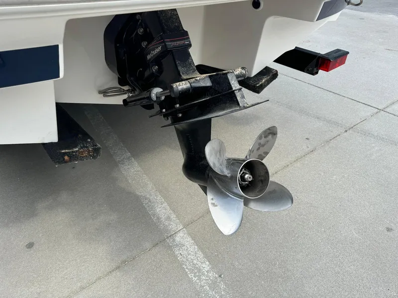 Slide: The Image of 2006 Regal 2200 Bowrider boat propeller and stern drive on concrete surface. - 8