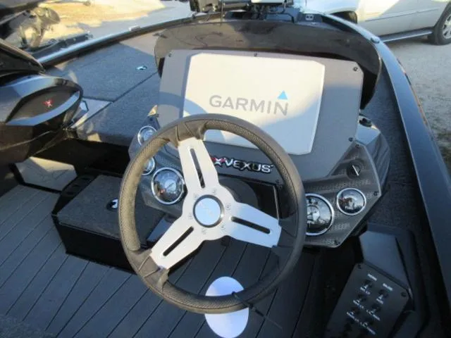 Slide: The Image of 2024 Vexus AVX1880 boat dashboard with Garmin display and steering wheel. - 15