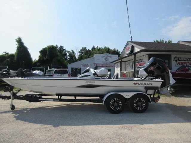 Slide: The Image of 2025 Vexus AVX 2080 boat with 200 Mercury Pro XS engine, parked outdoors. - 10