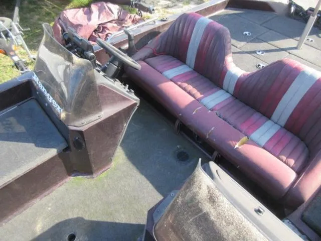 Slide: The Image of 1995 Ranger 392XT boat interior with maroon and gray seating, showing wear and tear. - 11