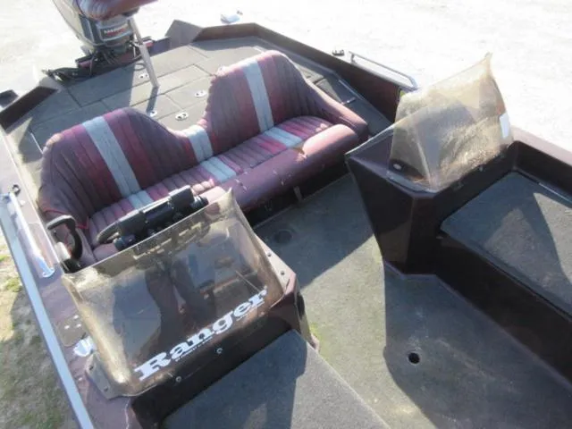 Slide: The Image of 1995 Ranger 392XT boat interior with striped seats and dual windshields. - 2