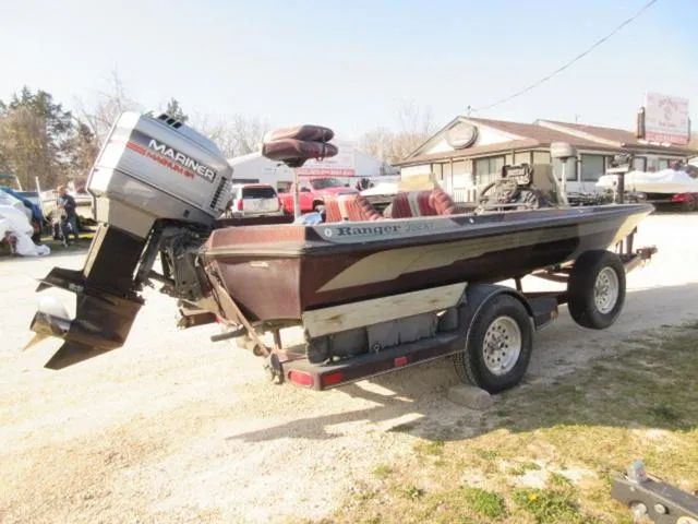 Slide: The Image of 1995 Ranger 392XT boat with Mariner 200 HP outboard on trailer, parked outdoors. - 6
