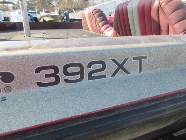Slide: The Image of 1995 Ranger 392XT boat with red seats and visible model branding. - 7