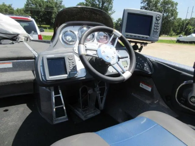 Slide: The Image of 2007 Ranger Z20 boat cockpit with steering wheel, gauges, and navigation screens. - 11
