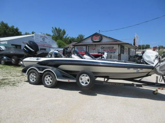 Slide: The Image of 2007 Ranger Z20 boat with Mercury 225 Optimax engine on a trailer, parked outdoors. - 2
