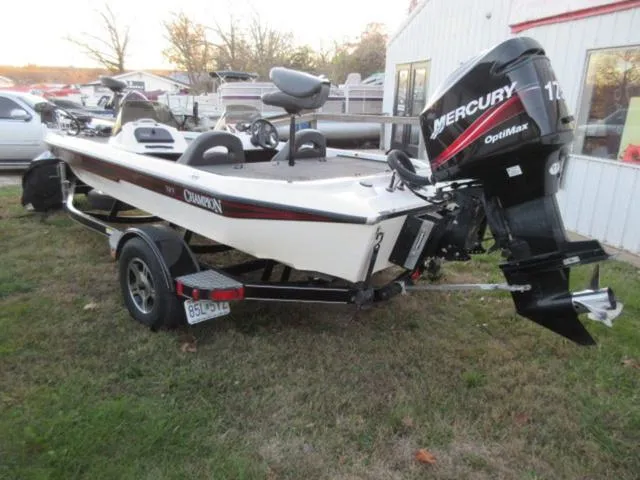 Slide: The Image of 2004 Champion 187 bass boat with Mercury 175Hp outboard, parked on grass. - 10