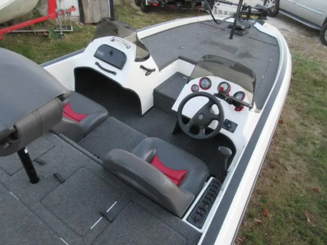 Slide: The Image of 2004 Champion 187 bass boat with Mercury 175Hp outboard, clean interior, dual seats, and control panel. - 12