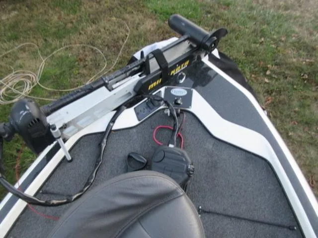 Slide: The Image of 2004 Champion 187 bass boat with Mercury 175Hp outboard, featuring clean deck and trolling motor. - 14