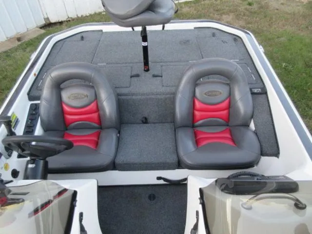 Slide: The Image of 2004 Champion bass boat interior with dual seats and Mercury 175Hp outboard. - 16