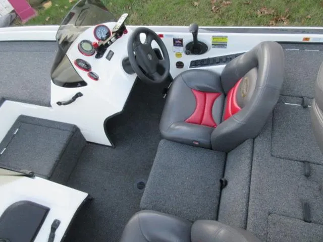 Slide: The Image of 2004 Champion 187 bass boat interior with steering wheel, gauges, and seating. - 21