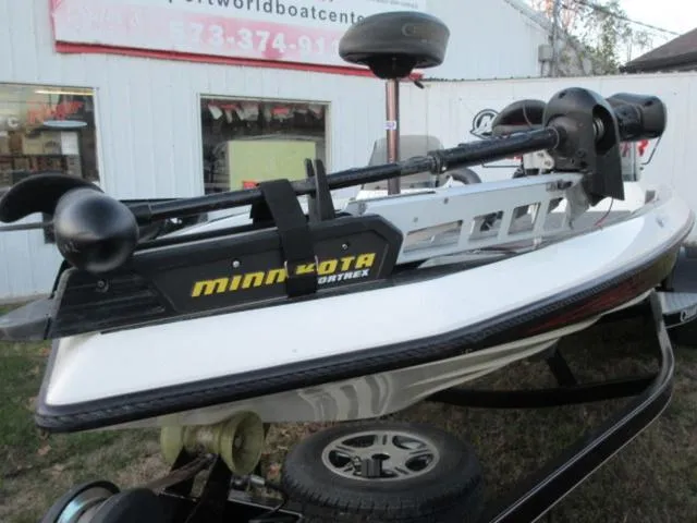 Slide: The Image of 2004 Champion bass boat with Minn Kota trolling motor, parked outside a boat center. - 7