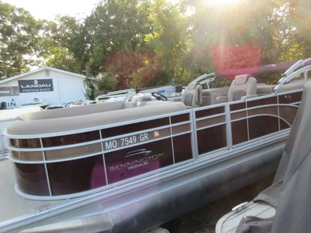 Slide: The Image of 2019 Bennington SX 23 Premier Tritoon with Mercury 225Hp engine, docked in sunlight. - 1