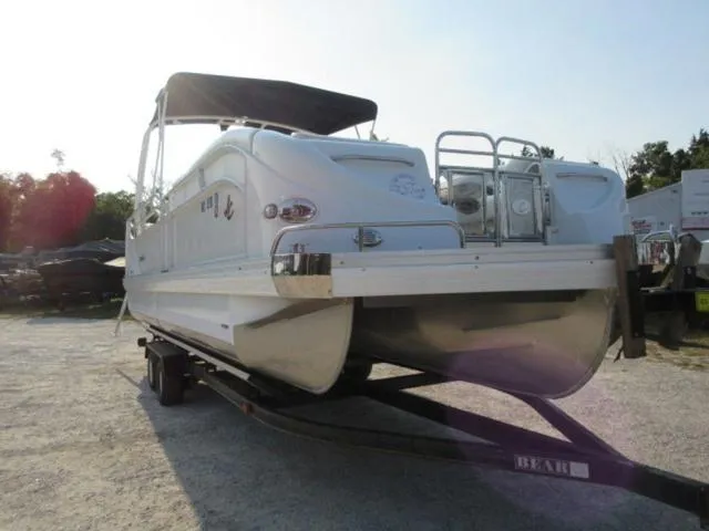 Slide: The Image of 2009 JC 26' Tritoon with 300Hp Evinrude Outboard on trailer, side view. - 16