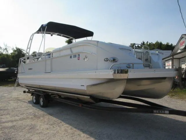 Slide: The Image of 2009 JC 26' Tritoon boat with 300Hp Evinrude outboard on trailer. - 17