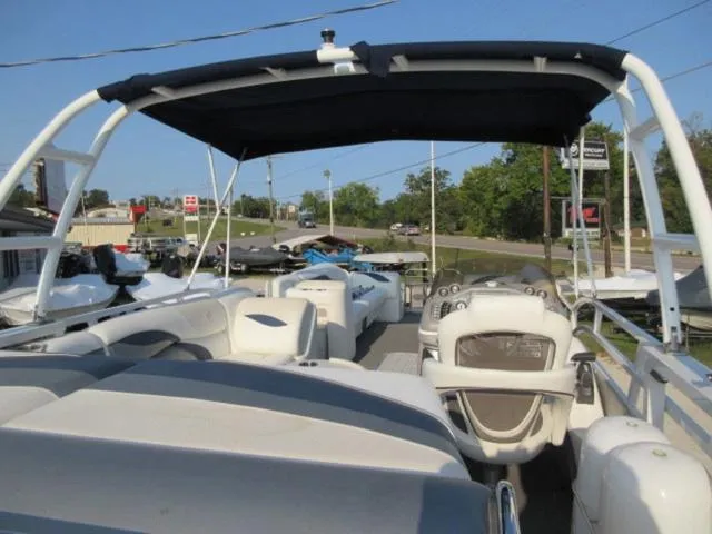 Slide: The Image of 2009 JC 26' Tritoon boat with 300Hp Evinrude outboard, featuring spacious seating and canopy. - 22