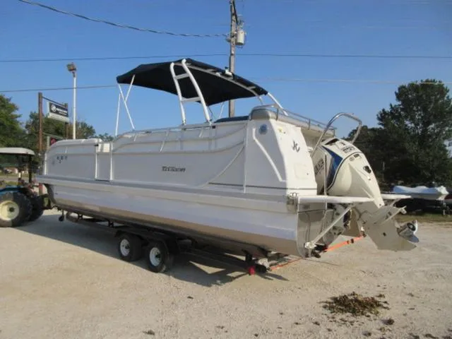 Slide: The Image of 2009 JC 26' Tritoon boat with 300Hp Evinrude outboard on trailer, side view. - 4