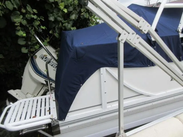 Slide: The Image of 2009 JC 26' Tritoon with 300Hp Evinrude outboard, covered and docked. - 9