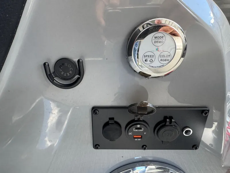 Slide: The Image of Control panel of 2023 Godfrey Monaco 255 SD boat with various switches and dials. - 16