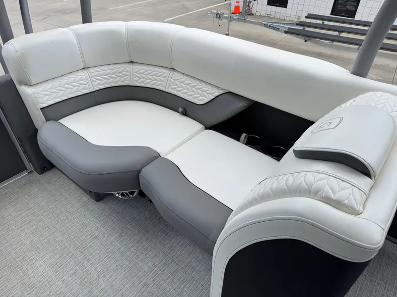 Slide: The Image of Luxurious seating on 2023 Godfrey Monaco 255 SD boat, featuring elegant white and gray upholstery. - 22