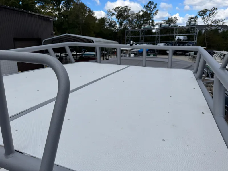 Slide: The Image of Rooftop view of 2023 Godfrey Monaco 255 SD boat, showcasing spacious deck and railings. - 24