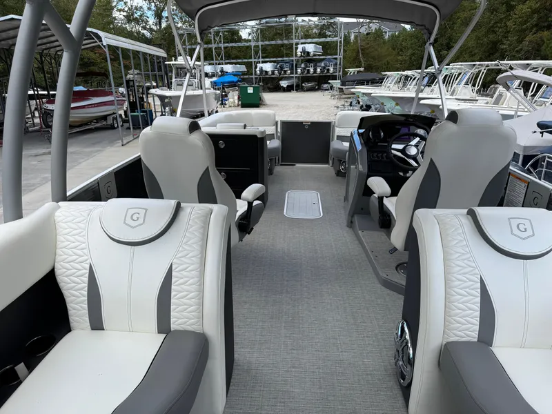 Slide: The Image of 2023 Godfrey Monaco 255 SD boat interior with luxurious seating and modern dashboard. - 26