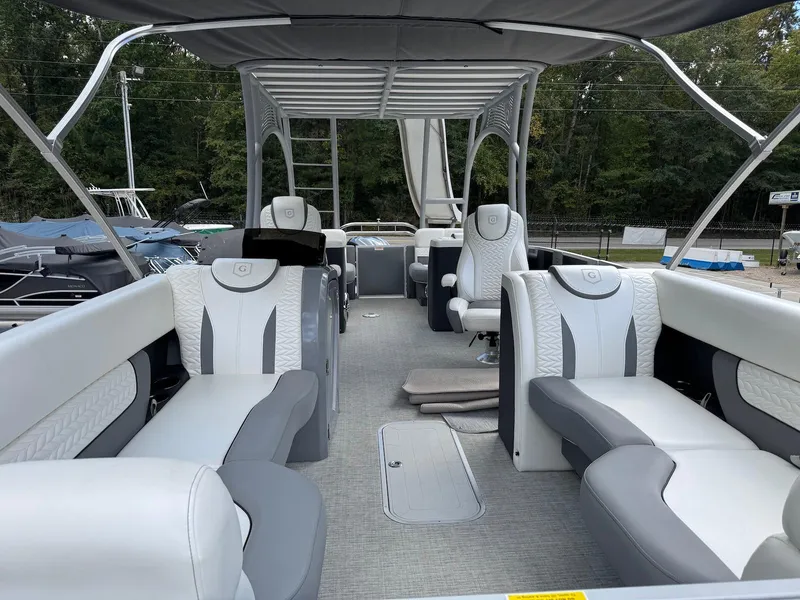 Slide: The Image of 2023 Godfrey Monaco 255 SD pontoon boat interior with luxurious seating and canopy. - 9