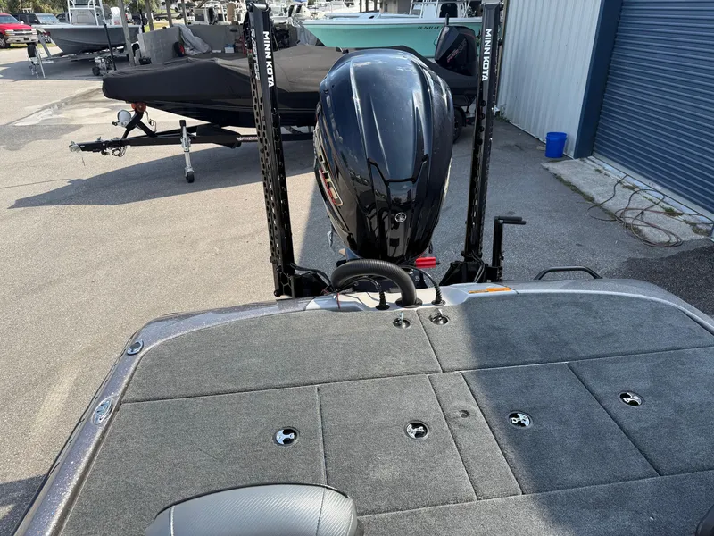 Slide: The Image of 2025 Skeeter ZXR20 boat with powerful outboard motor, parked outdoors. - 10