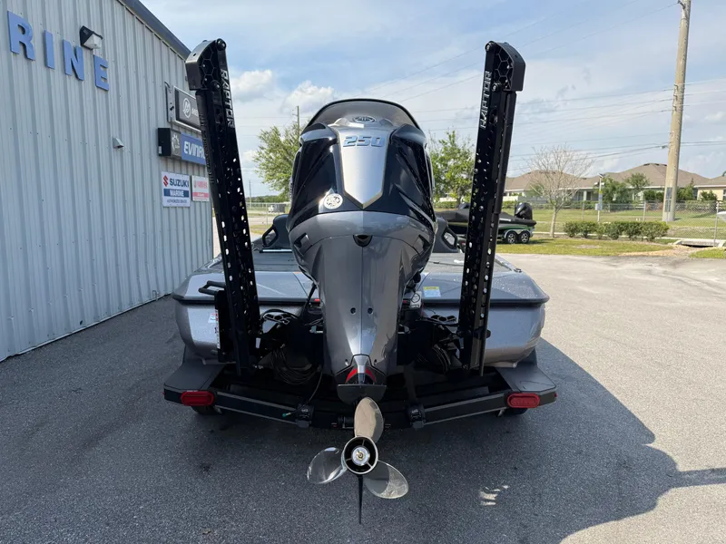 Slide: The Image of 2025 Skeeter ZXR20 boat with powerful outboard motor, parked near a marine facility. - 13